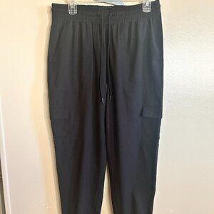 loose fit cargo black pants has draw string elastic waist on the bottom the legs